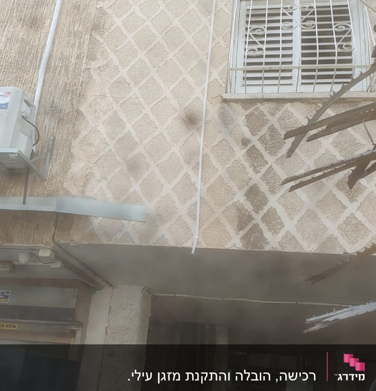 יחידת מזגן מותקנת על קיר חיצוני של בניין